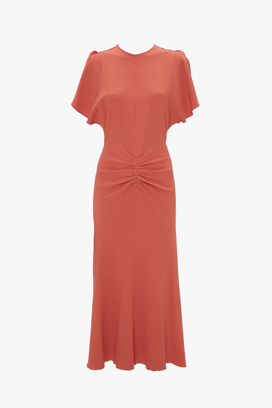 A Victoria Beckham papaya red knee-length dress with short sleeves, a round neckline, and a twisted knot detail at the waist.
