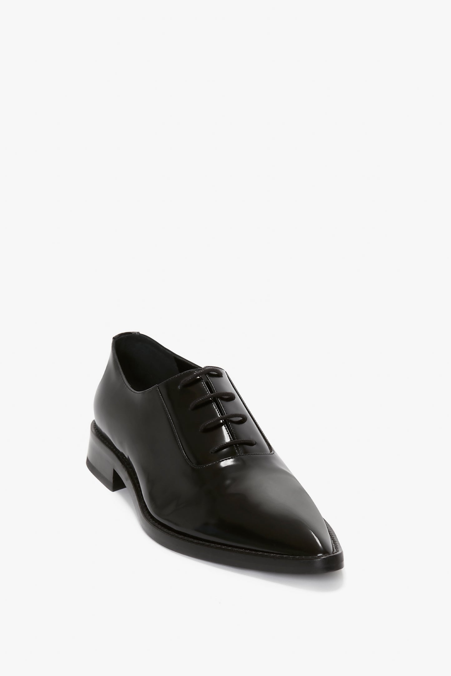 A Victoria Beckham Pointy Toe Flat Lace Up In Black Brushed Leather in brushed leather with laces, featuring a directional pointy toe and low heel, set against a white background.