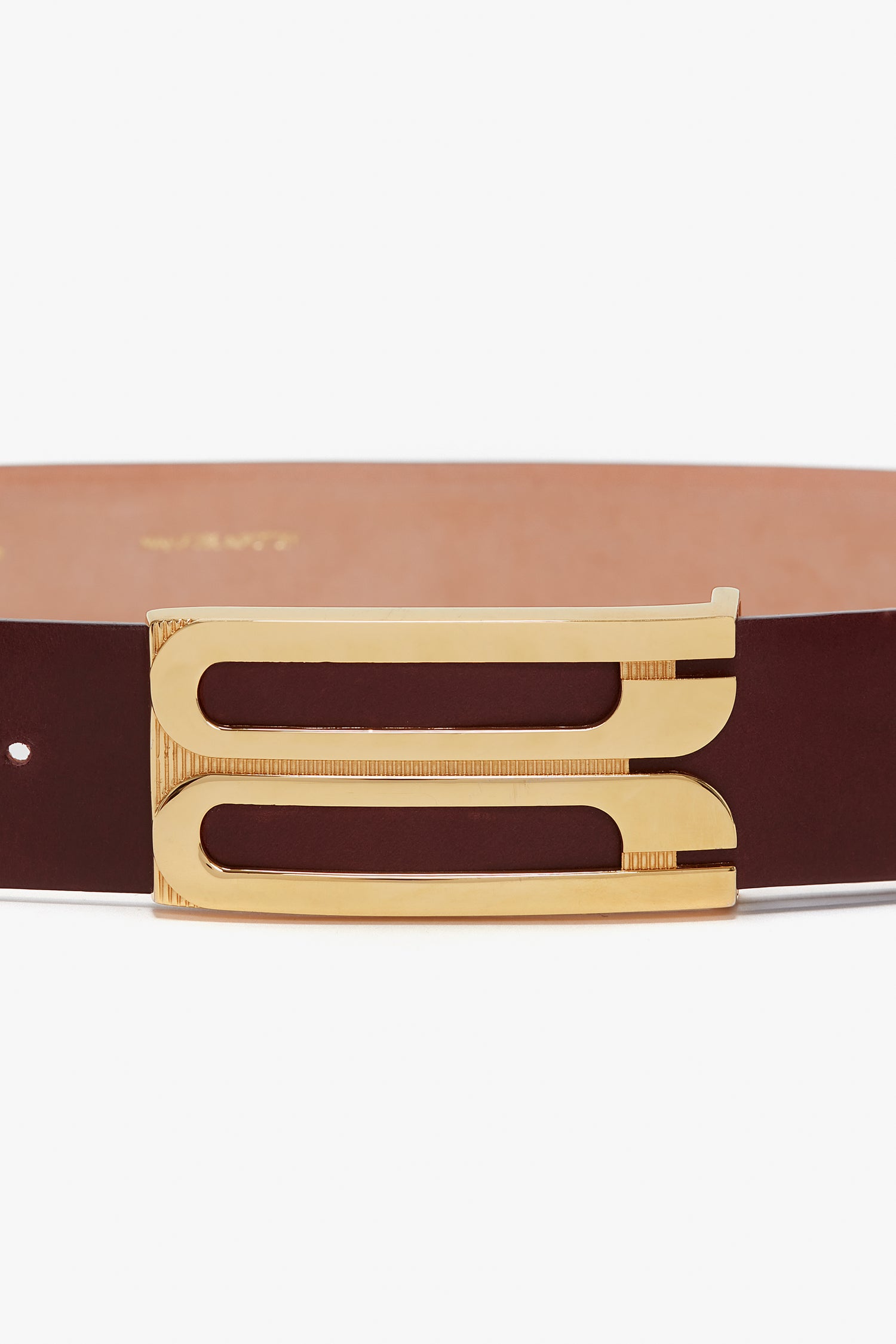 A contemporary brown calf leather belt with a gold rectangular buckle featuring two parallel cut-out slots is replaced by the Jumbo Frame Belt In Burgundy Leather from Victoria Beckham.