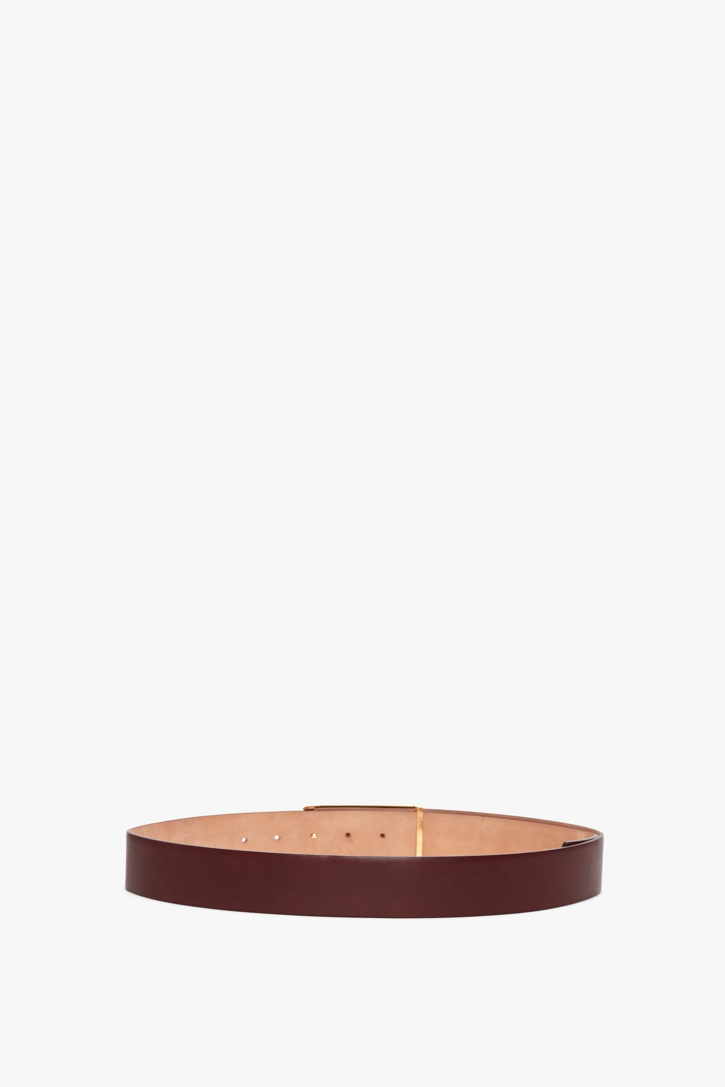 A contemporary Jumbo Frame Belt In Burgundy Leather from Victoria Beckham, crafted from premium calf leather, featuring a smooth, plain design and several holes for adjustment.