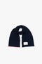 An Exclusive Logo Patch Scarf In Navy with a logo patch at one end and a red border on the other end, this luxury accessory embodies the elegance of Victoria Beckham's design.