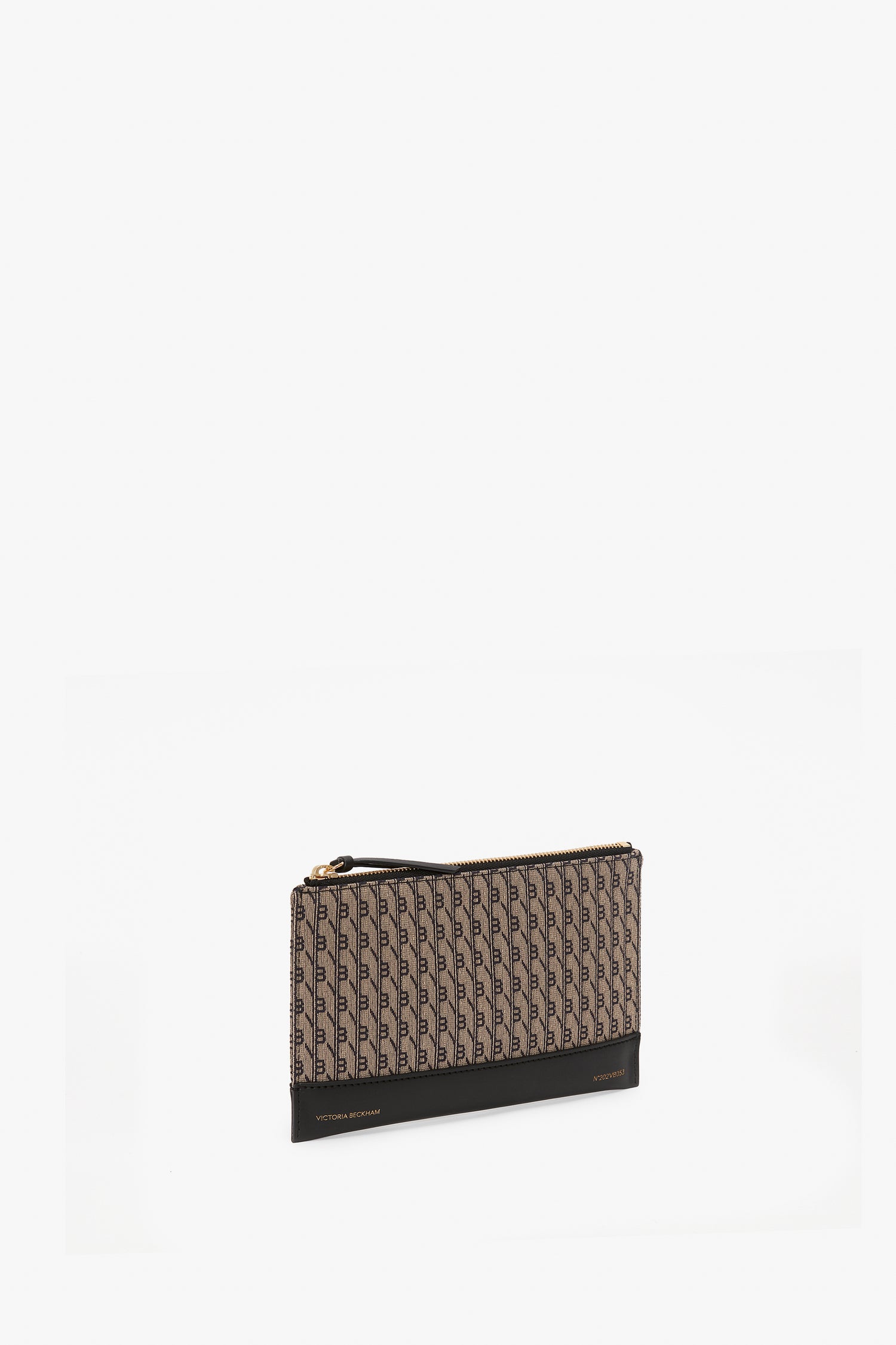 A brown and black rectangular clutch with a monogram motif and zipper closure, this Exclusive Beauty Pouch In VB Monogram from Victoria Beckham is the perfect blend of style and functionality.