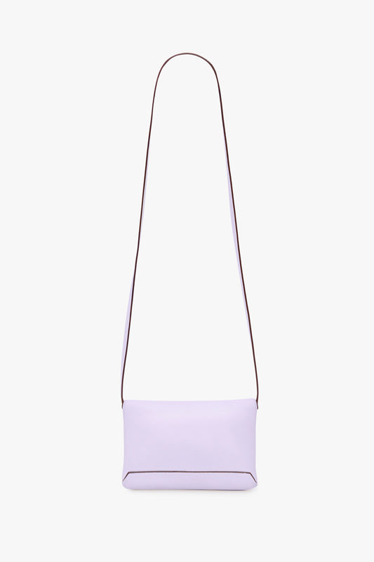 An Exclusive Mini Chain Pouch Bag With Long Strap In Lilac Leather by Victoria Beckham, set against a plain white background.