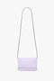 An Exclusive Mini Chain Pouch Bag With Long Strap In Lilac Leather by Victoria Beckham, set against a plain white background.