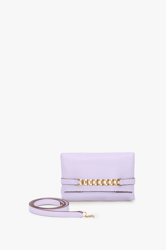 A Victoria Beckham Exclusive Mini Chain Pouch Bag With Long Strap In Lilac Leather with gold hardware and a detachable strap.