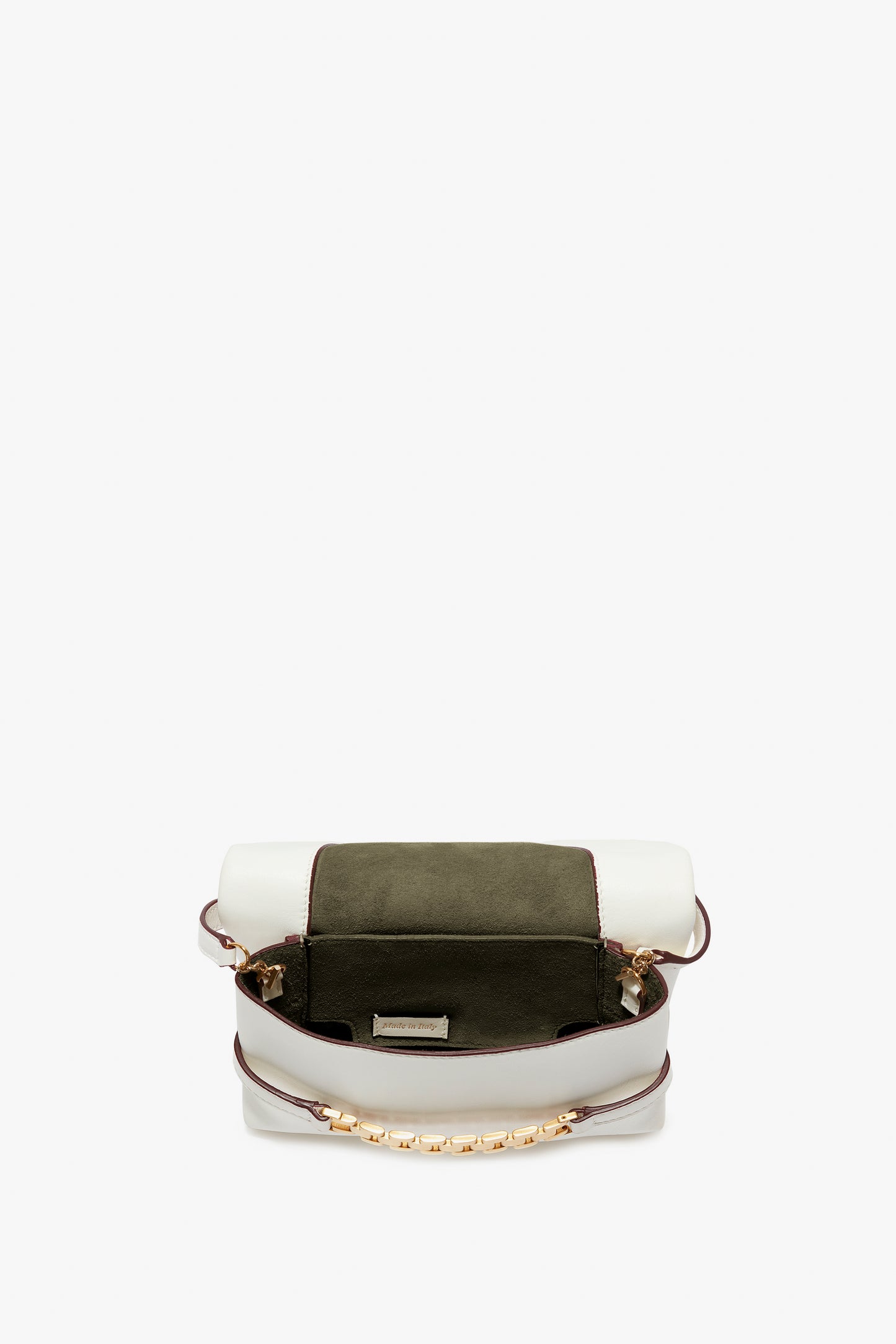 An open white Mini Chain Pouch Bag With Long Strap In White Leather by Victoria Beckham with a green interior and a removable strap, displayed against a plain white background.