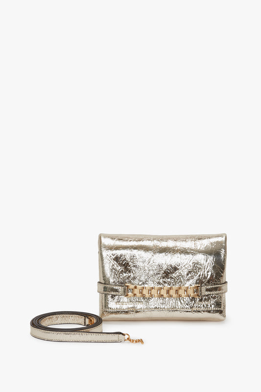 Metallic silver Mini Chain Pouch with a decorative front strap and a gold-tone chain, isolated on white background.

Product Name: Victoria Beckham Mini Chain Pouch With Long Strap In Gold Leather