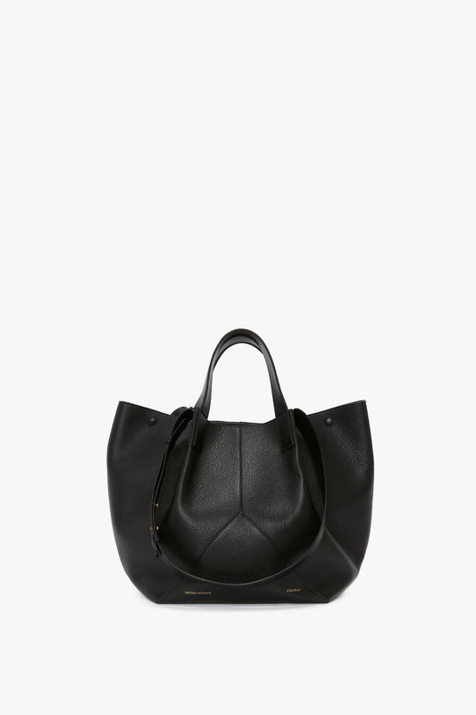 A W11 Medium Tote Bag In Black Leather by Victoria Beckham, featuring two short handles and a sleek, minimal design. Perfect for aficionados of luxury leather goods.