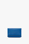 A minimalist Mini Chain Pouch Bag With Long Strap In Sapphire Blue by Victoria Beckham with a simple design is pictured against a plain white background, reminiscent of the elegant simplicity found in the Destiny Sandal collection.