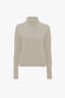 A Victoria Beckham Polo Neck Jumper In Ivory displayed against a white background.