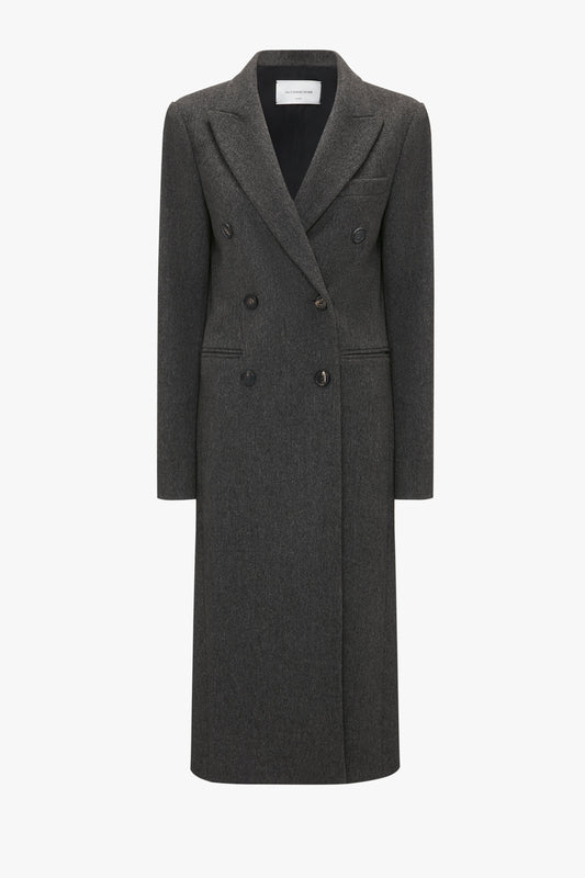 A full-length, dark grey, double-breasted Tailored Slim Coat In Grey Melange by Victoria Beckham featuring three buttons on each side and a notched lapel collar, this piece exudes classic military menswear charm while offering a flattering silhouette.