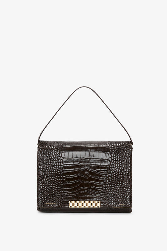 A Jumbo Chain Pouch Bag In Chocolate Croc-Effect Leather by Victoria Beckham with a top handle and a gold clasp, perfect for versatile styling.