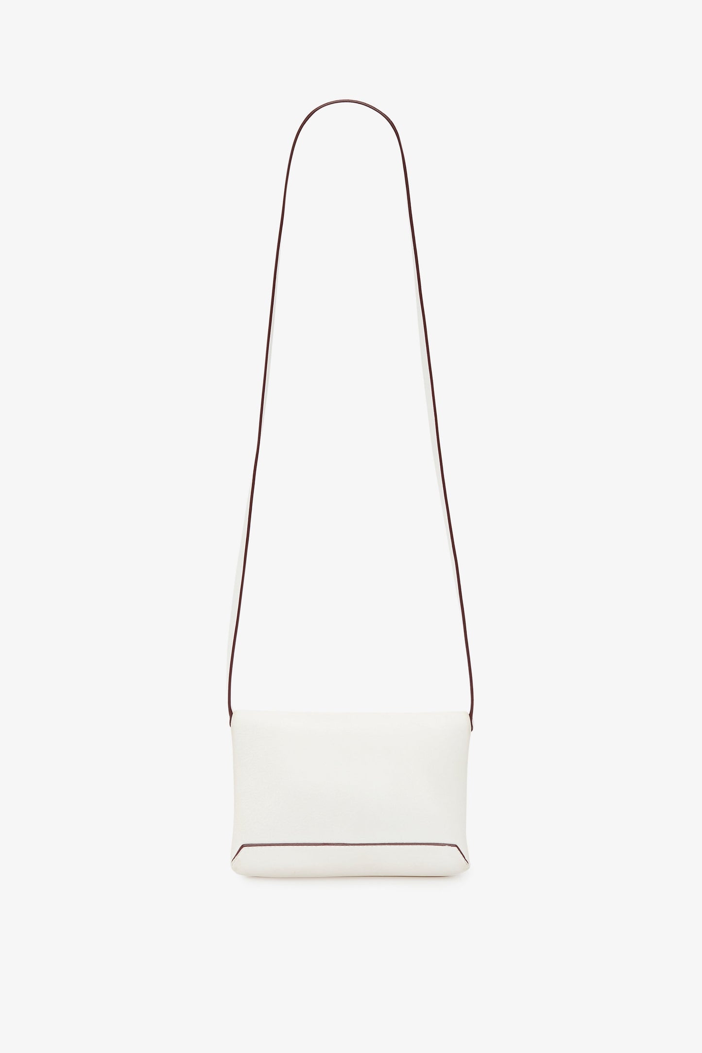 A chic white rectangular shoulder bag, reminiscent of Victoria Beckham's minimalist style, featuring a long, thin, removable strap. This Victoria Beckham Mini Chain Pouch Bag With Long Strap In White Leather is elegantly displayed against a plain white background.