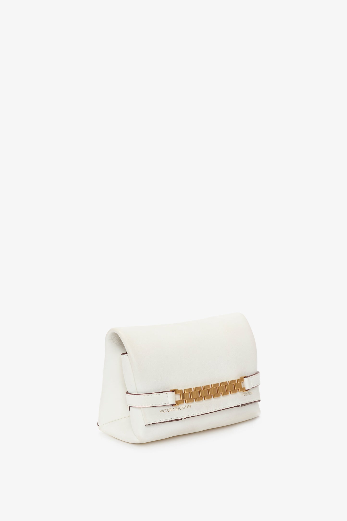 A **Mini Chain Pouch Bag With Long Strap In White Leather** with a fold-over flap and gold chain detail, featuring a minimalist design and subtle **Victoria Beckham** branding near the bottom. The handbag also includes a removable strap for versatile styling options.