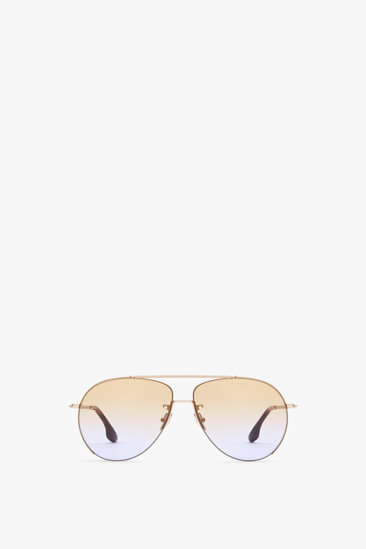 A pair of Fine Aviator in Gold Honey sunglasses from Victoria Beckham, with golden frames and gradient lenses, offering excellent UV protection, displayed on a plain white background.