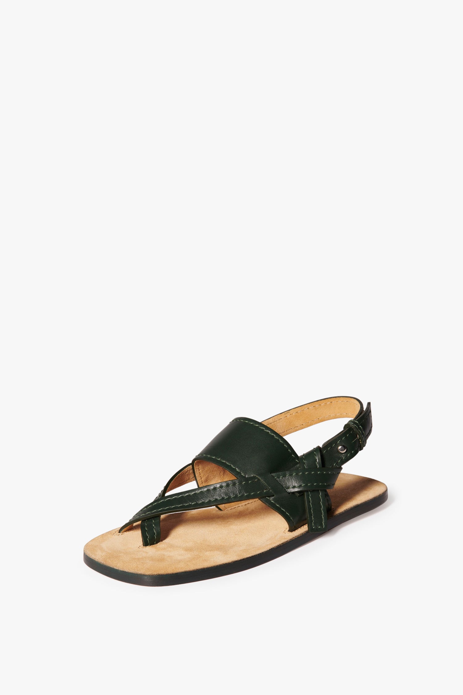 Single black sandal with a thong-style calf leather upper, a beige insole, and a flat black sole, displayed against a white background. This minimalist Eve Flat Sandal in Bottle Green by Victoria Beckham exudes elegance and simplicity.