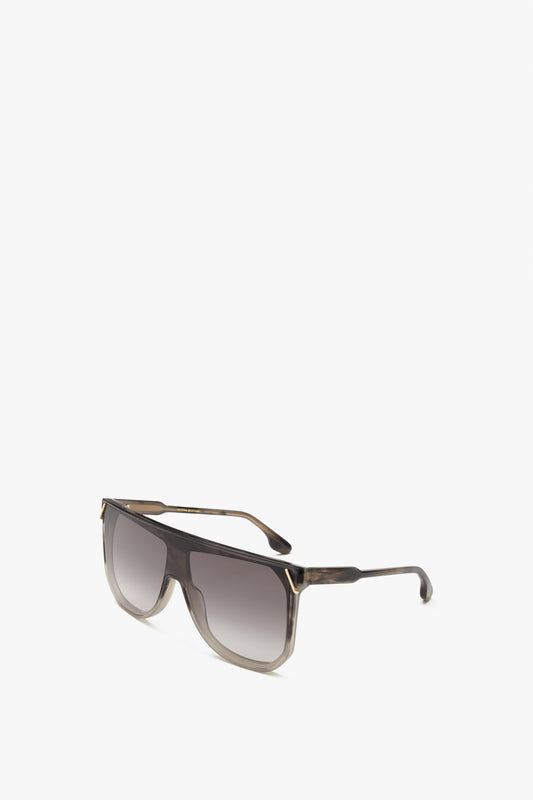 A pair of large, square-shaped Classic Flat Top V Sunglasses in Striped Grey with gradient lenses and a thin black frame, reminiscent of the chic designs from Victoria Beckham, placed on a white background.
