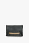 Chain Pouch Bag In Black Leather by Victoria Beckham with prominent gold-tone hardware across the front, displayed against a white background.