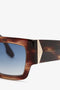 Close-up view of V Plaque Frame Sunglasses In Dark Brown Horn from Victoria Beckham, featuring a tortoiseshell acetate frame, gold-tone accents, and blue gradient lenses.