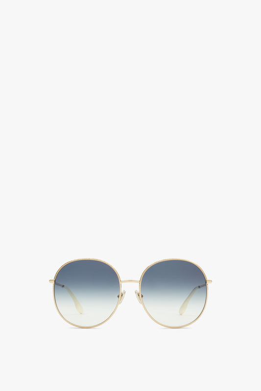 A pair of Hammered Round Sunglasses In Gold Blue by Victoria Beckham against a white background.