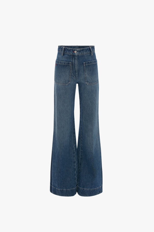 Rear view of blue high-waisted, wide-leg Alina High Waisted Jean In Shadow Wash by Victoria Beckham with a 70s-inspired flared leg, two large back pockets, and belt loops.