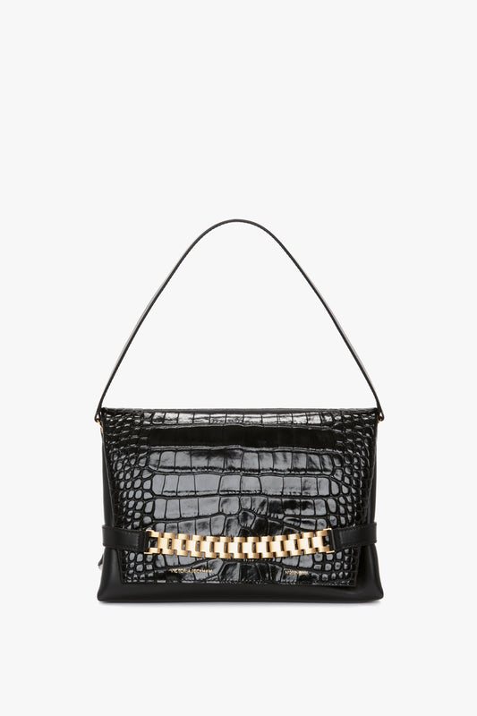 A Chain Pouch Bag With Strap In Black Croc-Effect Leather, exuding the sophistication of a Victoria Beckham accessory.