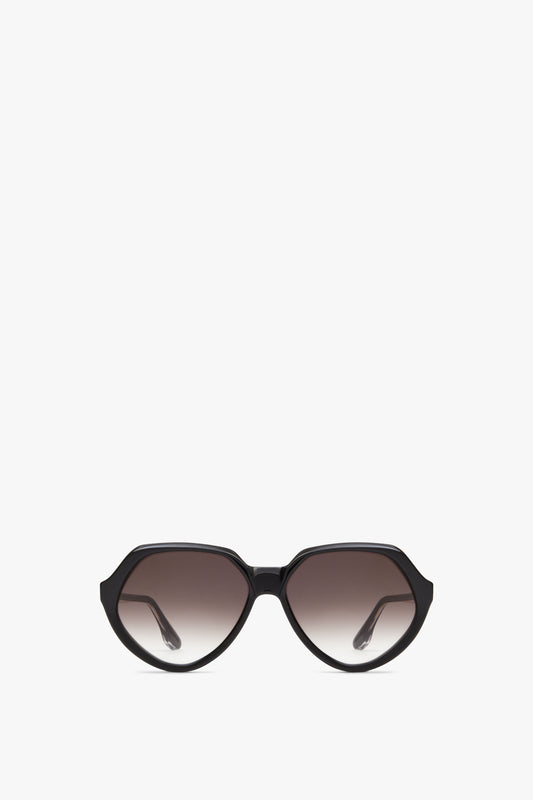 A pair of Victoria Beckham Faceted Round In Black sunglasses is centered against a white background.